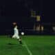 athlete kicking soccer ball in field