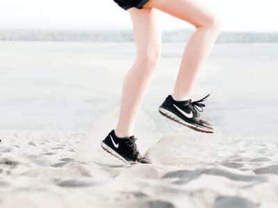 motivated athlete running on the beach